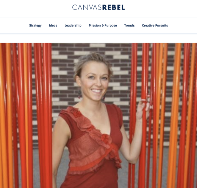 Image of female interior designer wearing red while standing between red vertical partitions