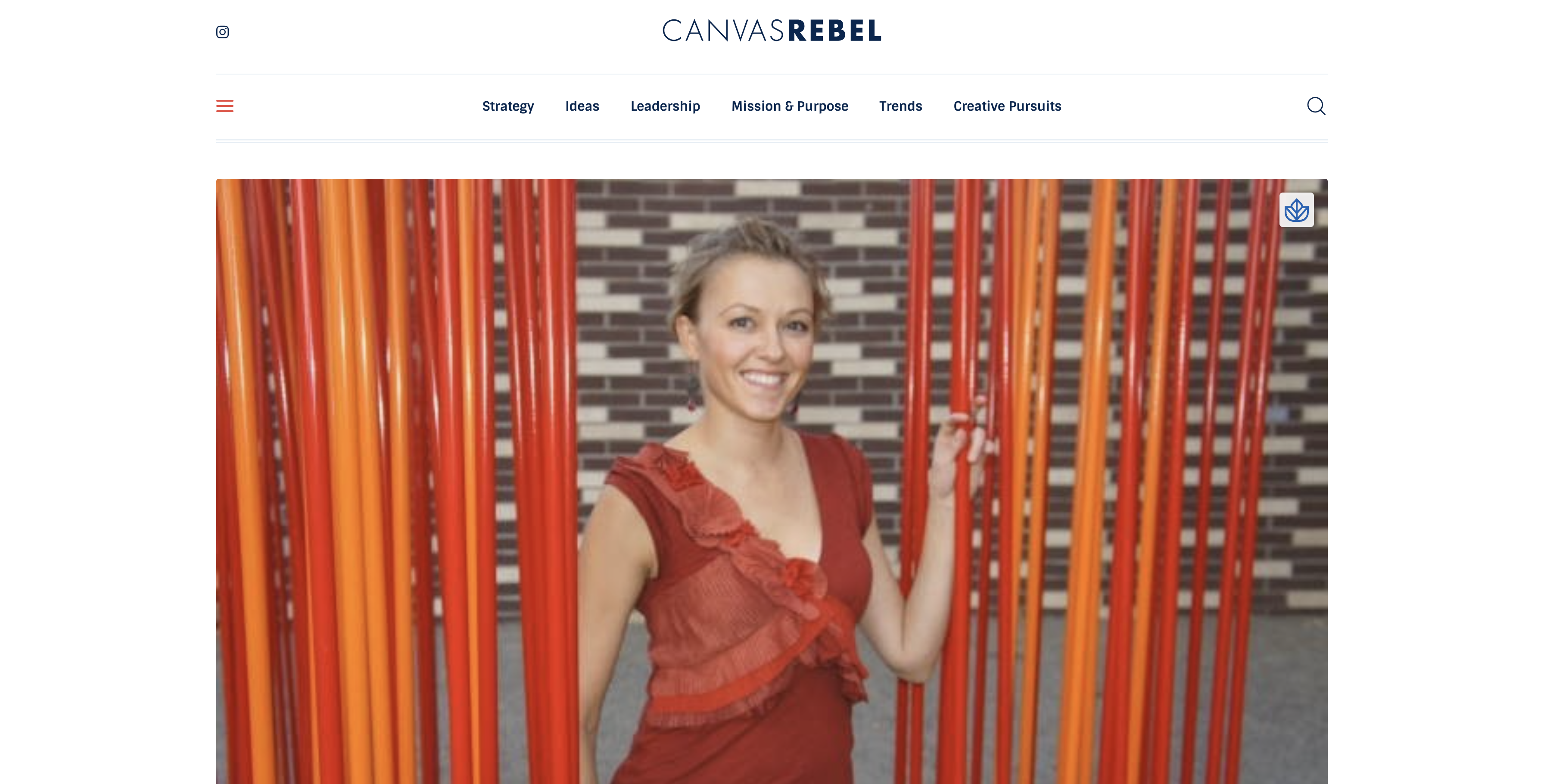 Image of female interior designer wearing red while standing between red vertical partitions